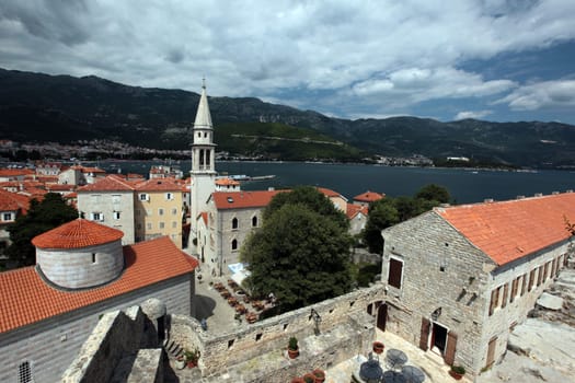 The old town with the church Of Sv. Ivan Krstitelji of the Adriatic city of Budva with many new apartments in Montenegro in the Balkans on the Mediterranean Sea in Europe.