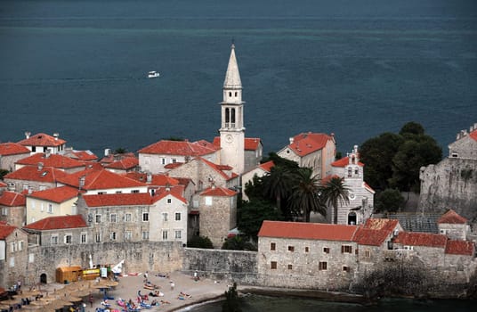 The old town with the church Of Sv. Ivan Krstitelji of the Adriatic city of Budva with many new apartments in Montenegro in the Balkans on the Mediterranean Sea in Europe.