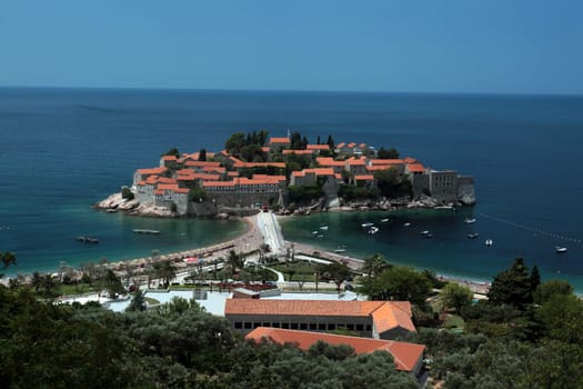 The old town island of Sveti Stefan in the Adriatic Sea on the coast in Montenegro in the Balkans on the Mediterranean Sea in Europe.