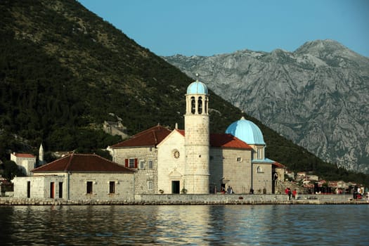 The monastery island and island of Gospa od Skrpjela off Persat in the inner bay of Kotor in Montenegro in the Balkans on the Mediterranean Sea in Europe.