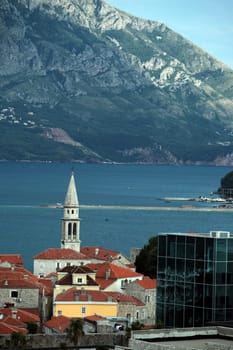 The old town with the church Of Sv. Ivan Krstitelji of the Adriatic city of Budva with many new apartments in Montenegro in the Balkans on the Mediterranean Sea in Europe.