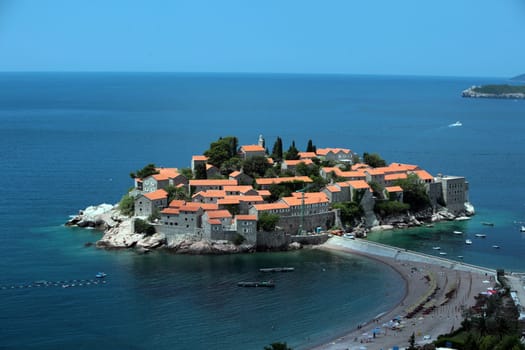 The old town island of Sveti Stefan in the Adriatic Sea on the coast in Montenegro in the Balkans on the Mediterranean Sea in Europe.