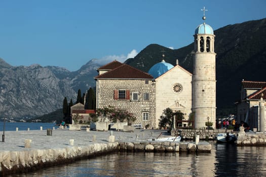 The island of Skrpjela in front of the village of Persat in the bay of Kotor on the Mediterranean Sea in Montenegro in the Balkans in Europe.