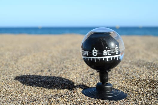 Orientation Concept One Compass on the Beach near the Atlantic Ocean