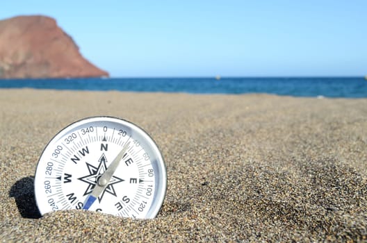 Orientation Concept One Compass on the Beach near the Atlantic Ocean