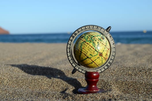 Globe Earth on the Beach near Ocean