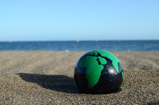 Globe Earth on the Beach near Ocean