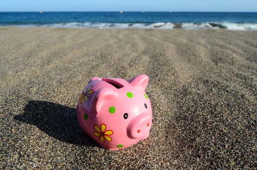 Piggy Bank on the Beach Saving for Vacation Concept
