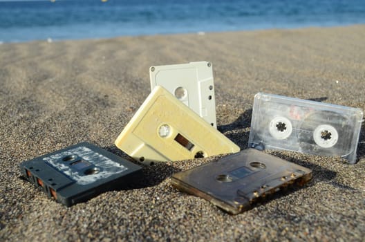 Ancient Retro Musicassette on the Sand near the Water
