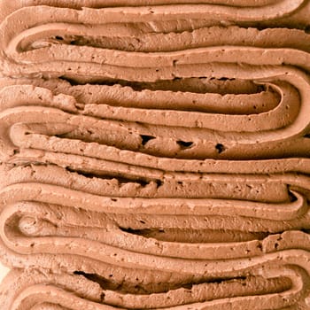 Rich chocolate Italian ice cream background texture with decorative ridged swirls of creamy summer dessert