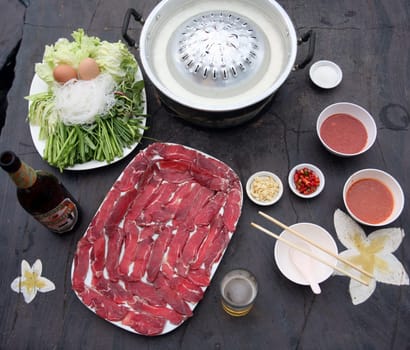 A meat grill or hotpot menu at a restaurant in the town of Savannahet in central Laos on the border with Thailand in South East Asia.