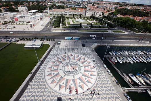 The view from the viewpoint of Padrao dos Descobrimentos to the seafaring world map on the forecourt and the Jeronimus monastery in Belem in Lisbon,Portugal.