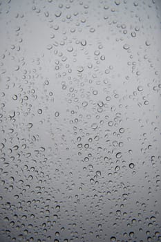 A close up shot of rain droplets on a window