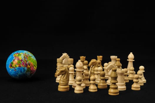 Globe And White Chess on a Black Background