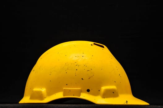 Yellow Safety Helmet on a Black Background