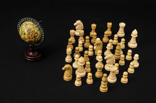 Globe And White Chess on a Black Background
