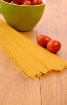 Spaghetti with tomatoes on a wooden table
