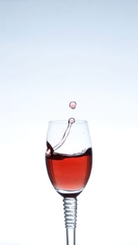 Splashing red wine on a blue background