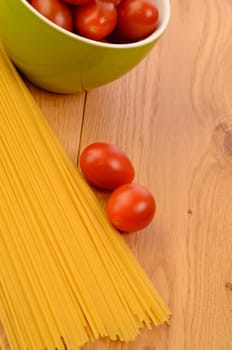 Spaghetti with tomatoes on a wooden table