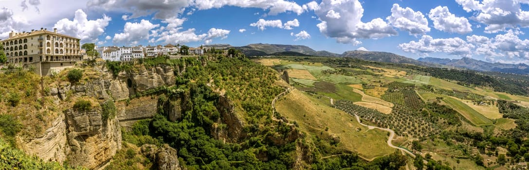 Ronda panoramic view. A city in the Spanish province of Málaga, within the autonomous community of Andalusia. Is situated in a very mountainous area about 750 m above mean sea level. The Guadalevín River runs through the city, dividing it in two and carving out the steep, 100 plus meters deep El Tajo canyon upon which the city perches