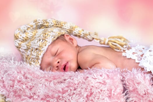 newborn girl with cap