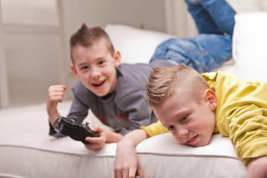two little boys having lots of fun with video games