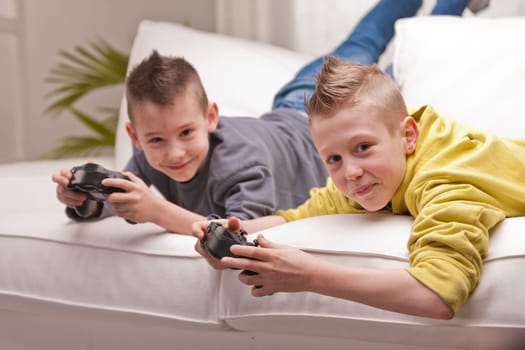 two little boys having lots of fun with video games