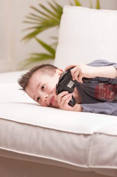 Kid having fun with video games in a brighly lit living room