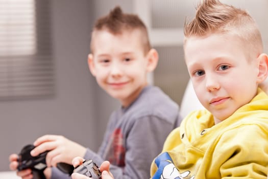 two little boys having lots of fun with video games