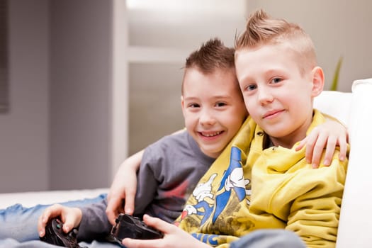 two little boys having lots of fun with video games