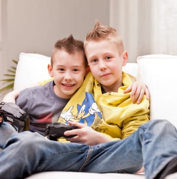 two little boys having lots of fun with video games