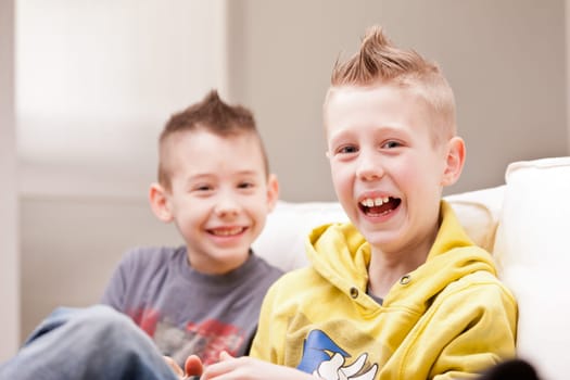 two little boys having lots of fun with video games