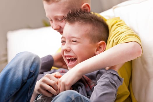 two little boys maybe friends or brothers two little boys laughing about tickling