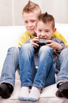 two little boys having lots of fun with video games