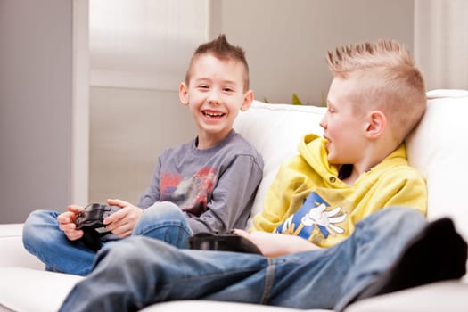 two little boys having lots of fun with video games