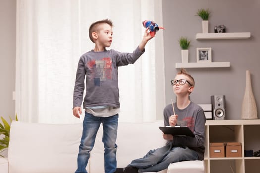 two boys playng as scientists and rocket inventors