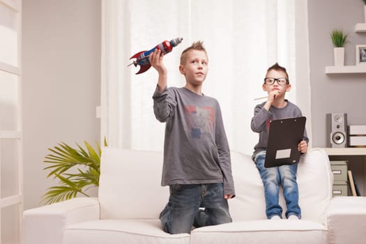 two boys playng as scientists and rocket inventors