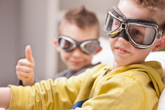 a couple of kids pretending to be pilots and playing with videogames