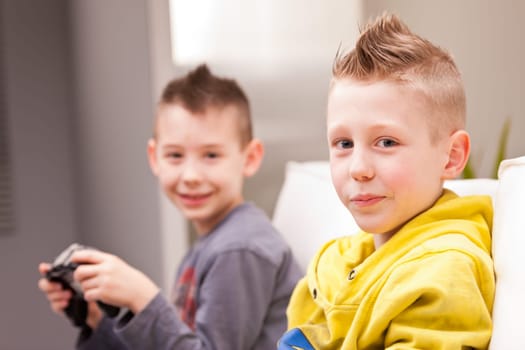 two little boys having lots of fun with video games