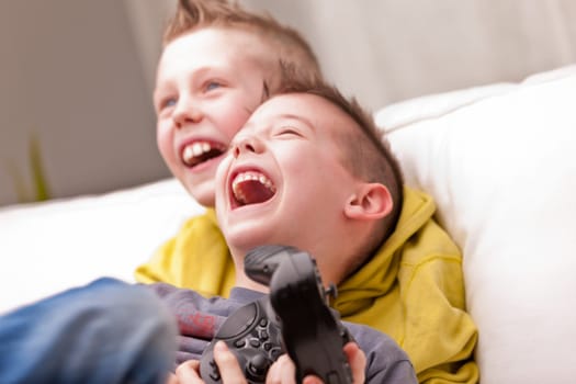 two little boys having lots of fun with video games