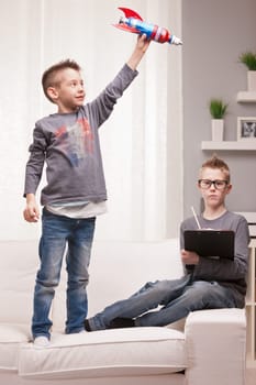 two boys playng as scientists and rocket inventors