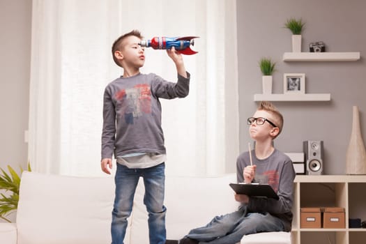 two boys playng as scientists and rocket inventors