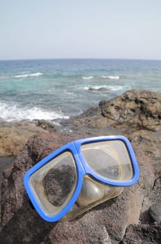 Blue Old Diving Mask on the Rocks near the Beach