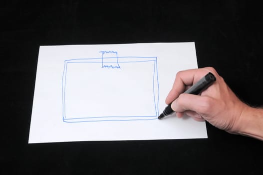 A Caucasian Male Hand Drawing on a White Paper