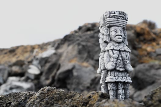 Ancient Maya Statue on the Rocks near the Ocean