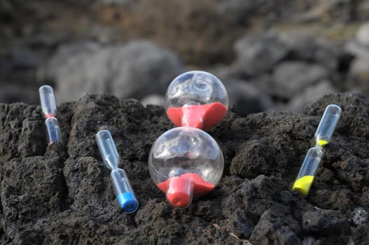 Time Concept - Hourglass Abandoned on the Volcanic Rocks