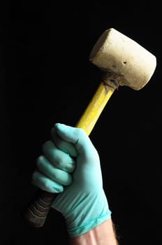 Hammer and a Hand on a Black Background