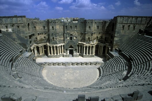 The citadel with the theater in the Old City of Bosra in the south of Syria in the Middle East in Arabia.