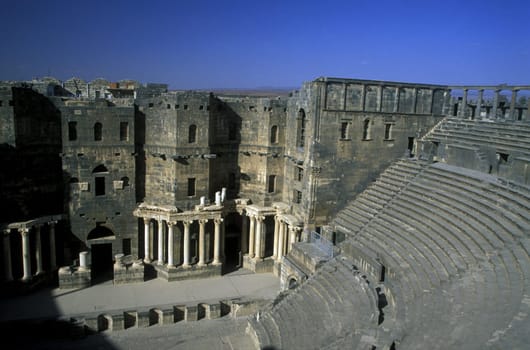 The ruins of the Roman Theatre in the town of Bosra in the south of Syria in the Middle East.