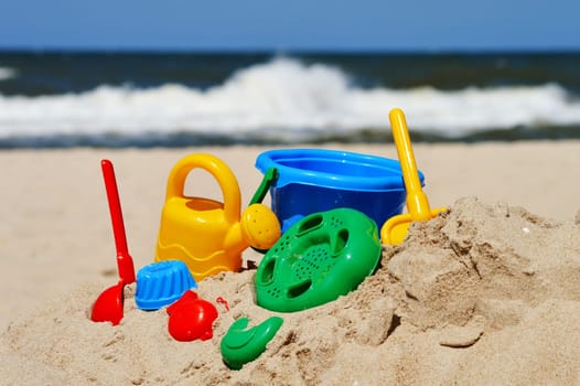 Plastic children toys on the sand beach